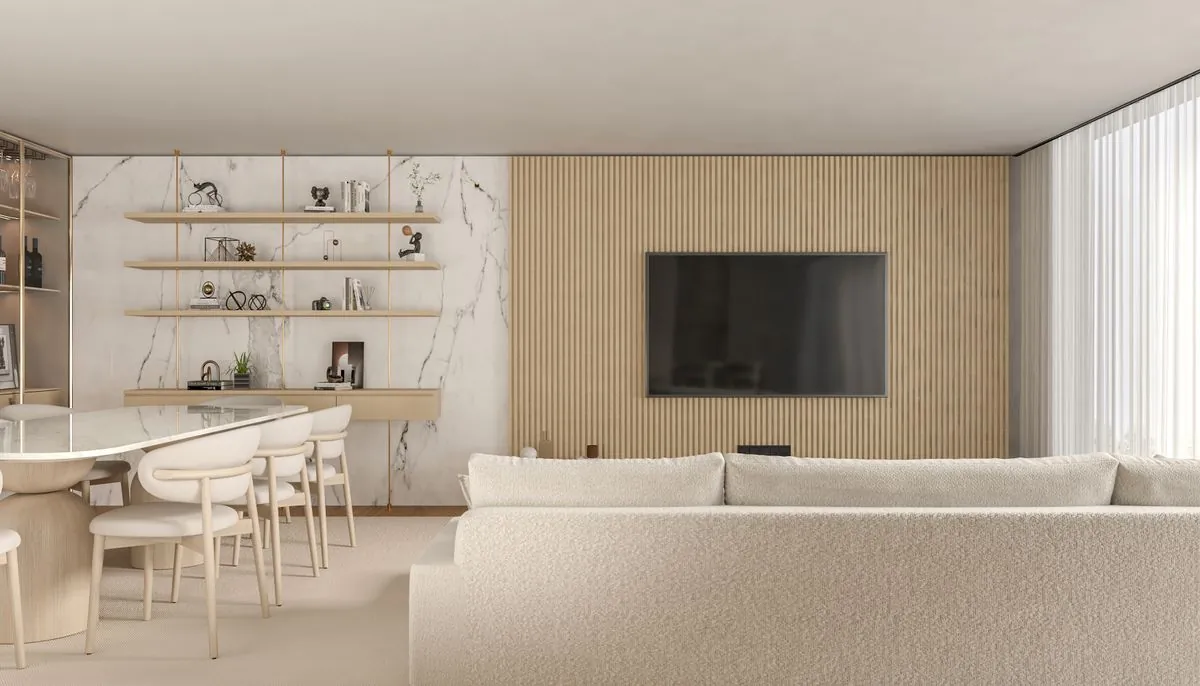 A pale living room with a long sofa and built-in shelves