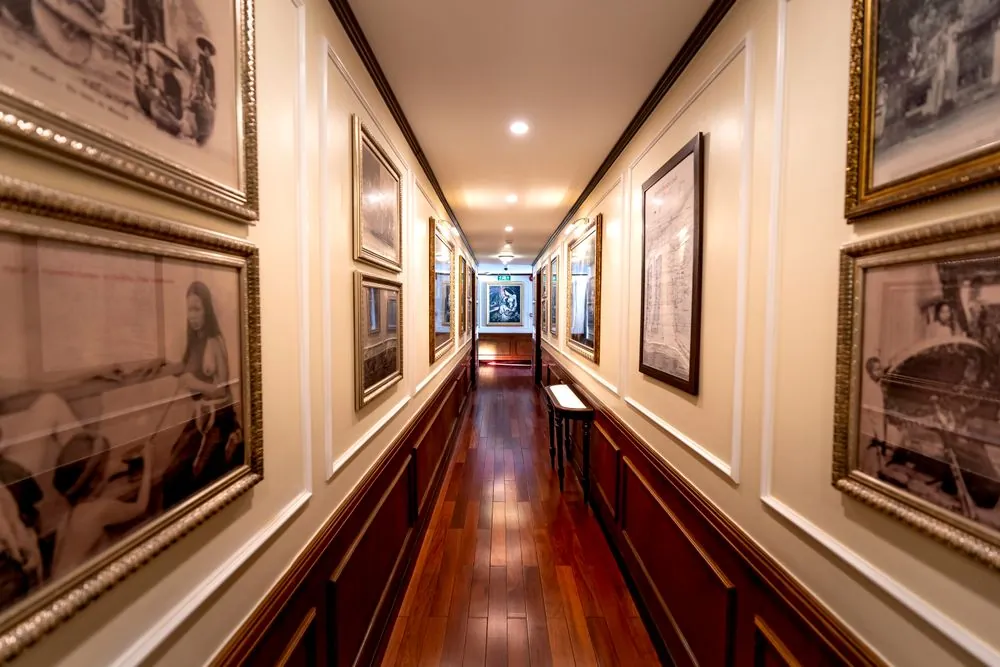 A long hallway hung with framed prints