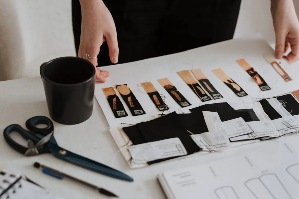 A flat lay of paint and fabric samples with drawings