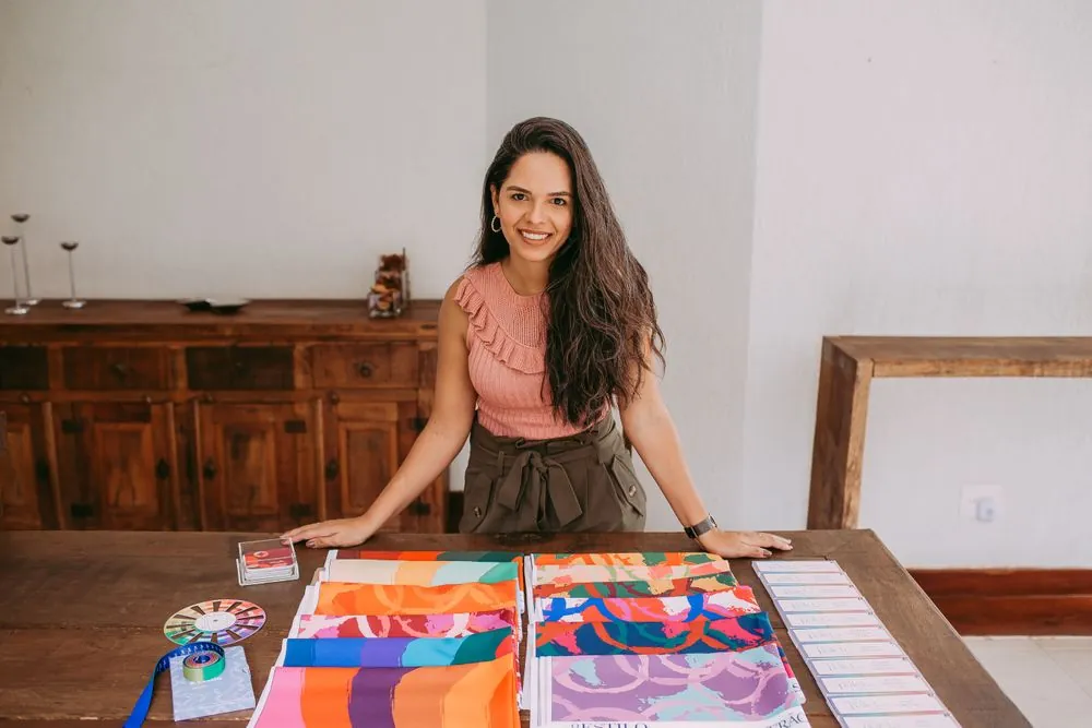 A designer at a table covered in fabric samples